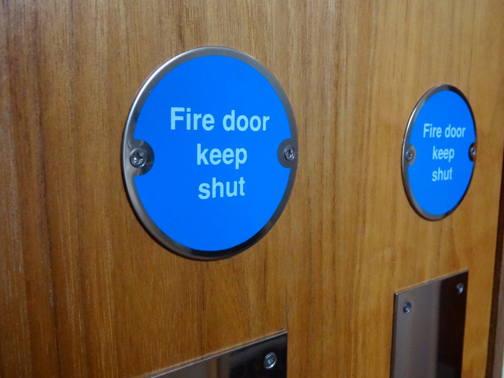 Circular blue Fire Door Keep Shut safety sign